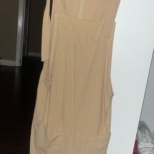 tan colored romper with 2 pockets in the front!